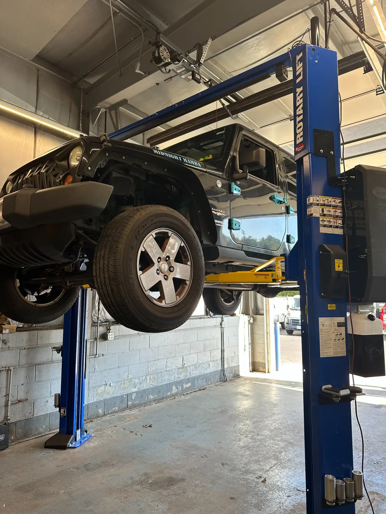 Jeep positioned on a commercial vehicle lift