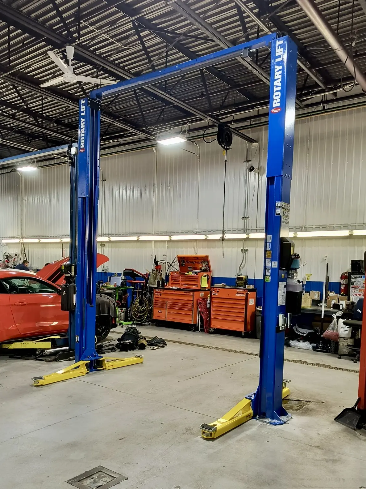 Blue Rotary two-post lift installed in a clean bay
