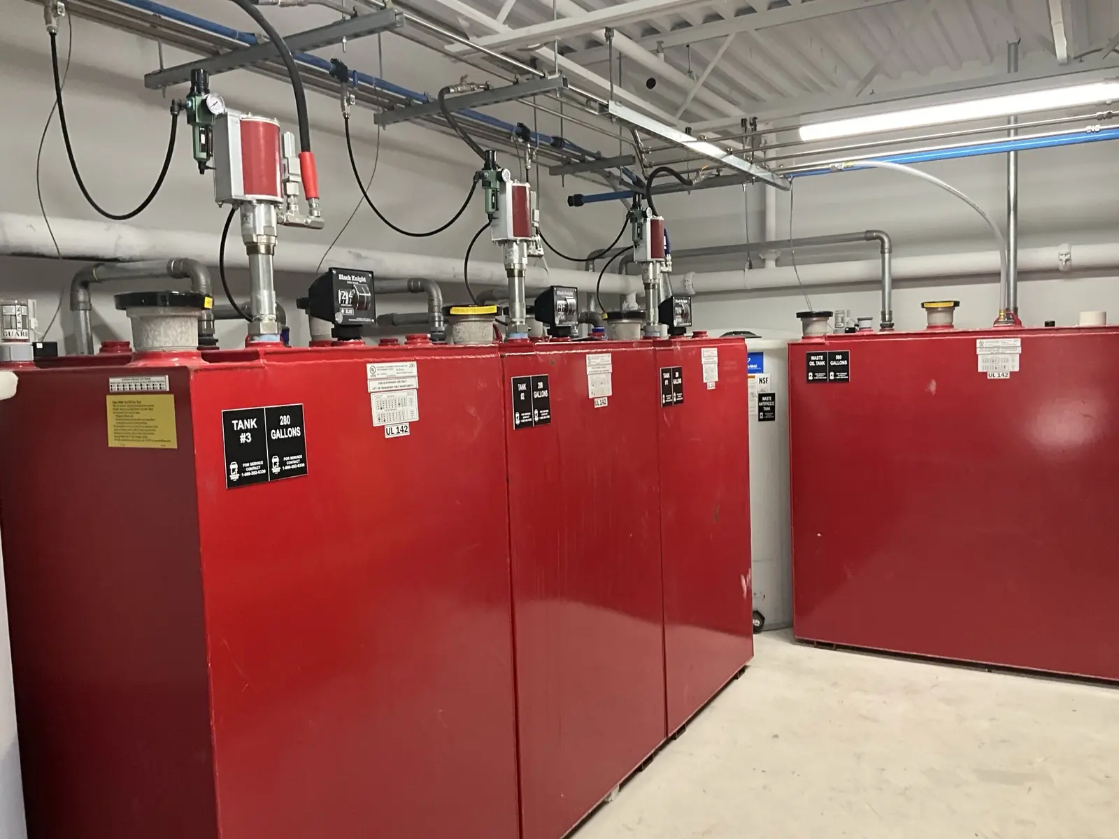 Bulk oil and fluid tanks with installed pumps and piping