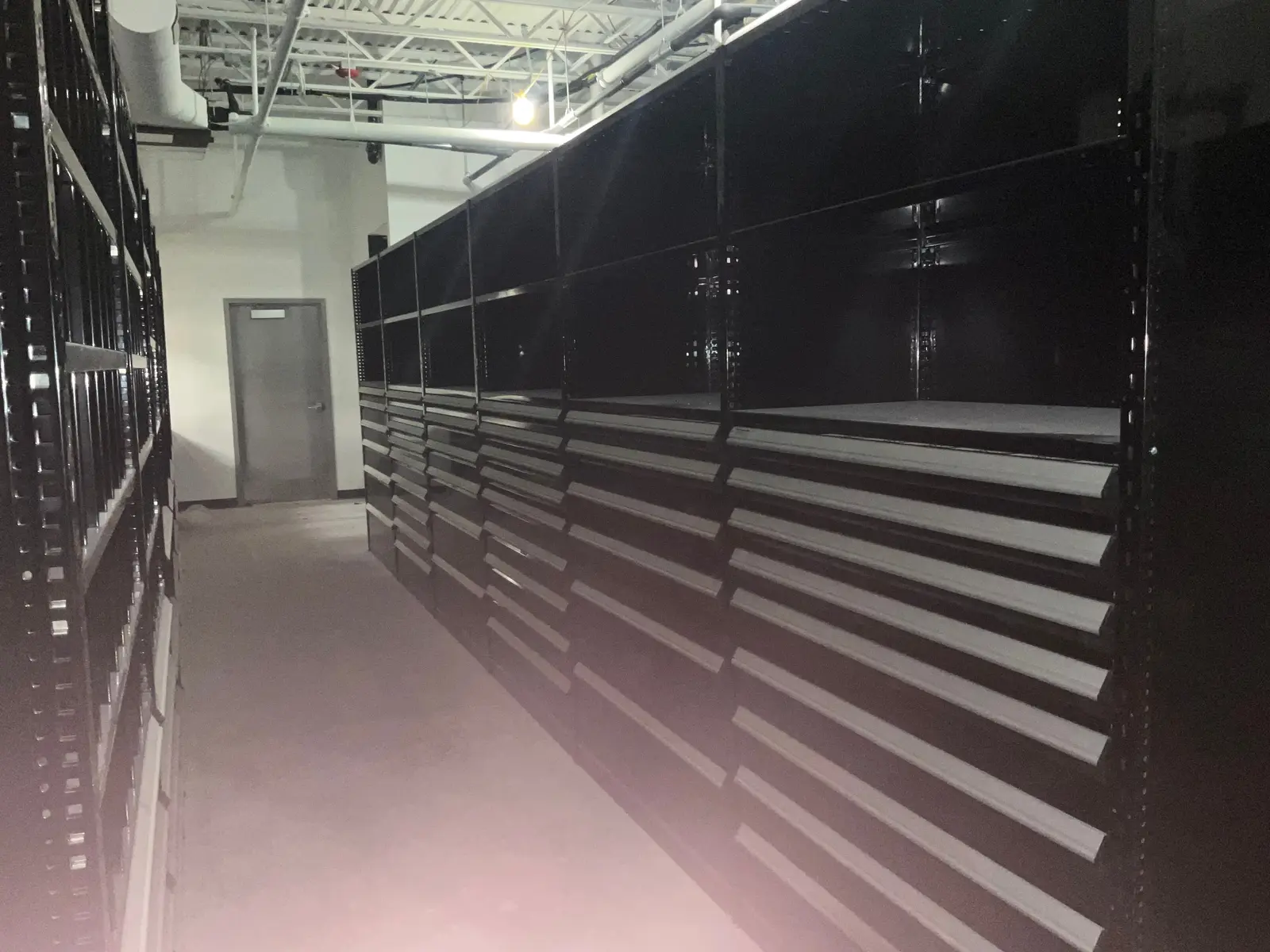 Wall of installed shop storage cabinets and drawer systems