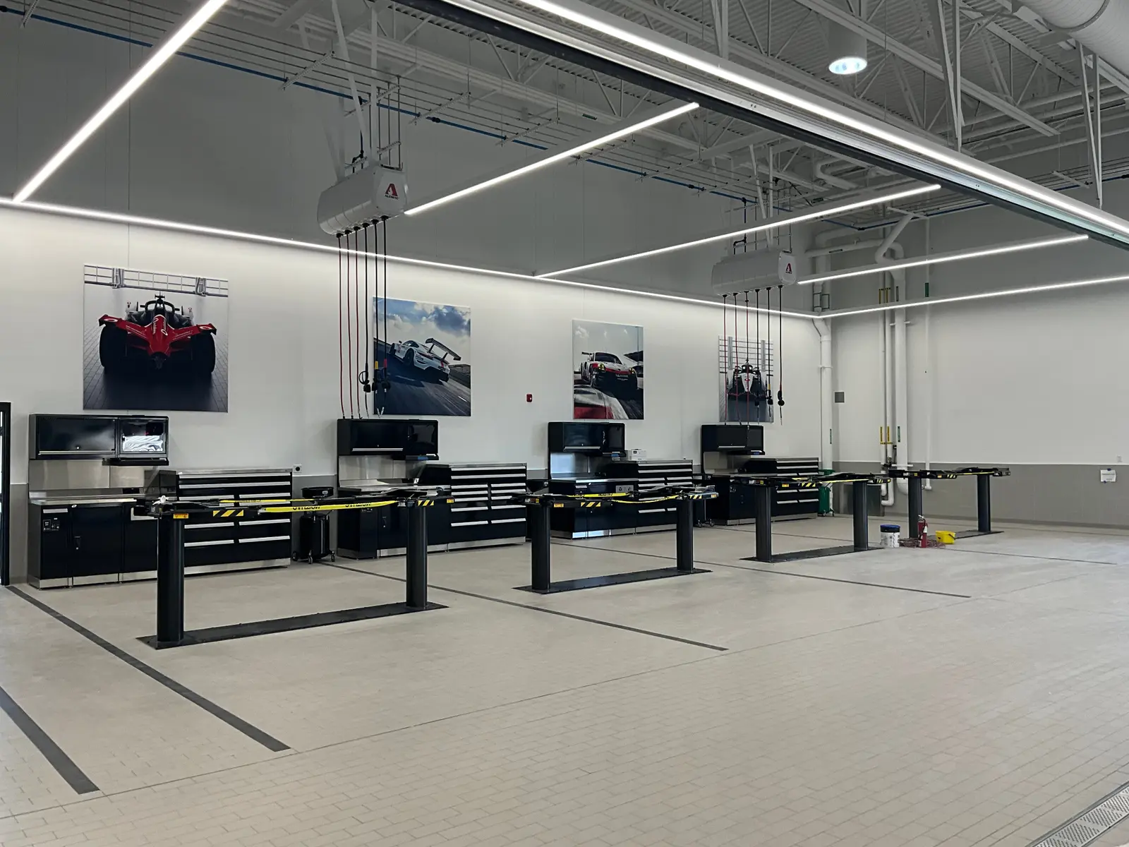 Integrated technician workstations and storage across finished service bays